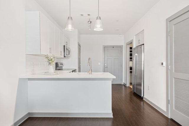 1638 54th Ave N Unit 313, Nashville, TN 37209 - kitchen with white cabinetry, appliances with stainless steel finishes, a peninsula, visible vents, and dark wood-style flooring