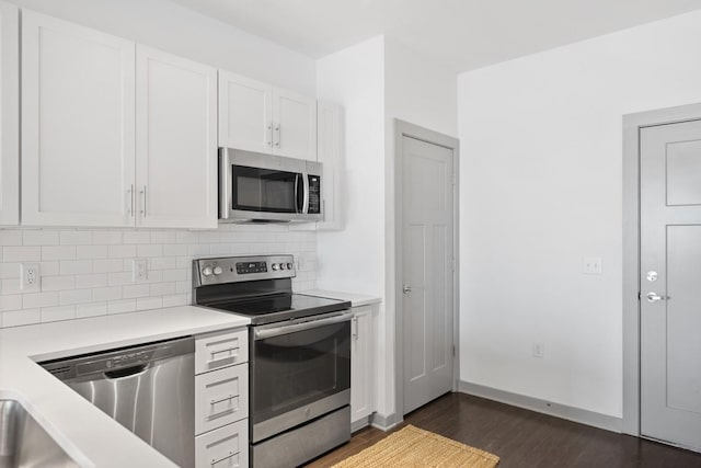 1638 54th Ave N Unit 313, Nashville, TN 37209 - kitchen featuring light countertops, white cabinetry, tasteful backsplash, appliances with stainless steel finishes, and dark wood-type flooring