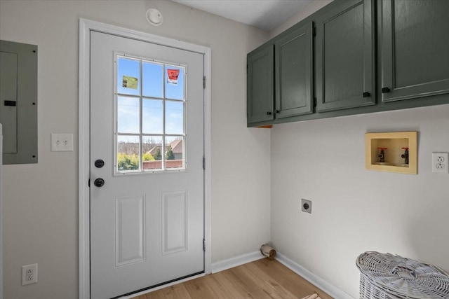 650 Wall Rd, Cunningham, TN 37052 - washroom with electric panel, washer hookup, hookup for an electric dryer, light wood-style floors, and cabinet space