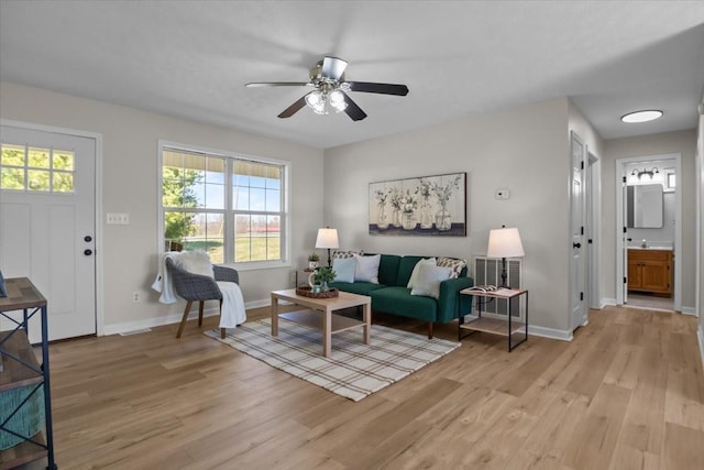 650 Wall Rd, Cunningham, TN 37052 - living room featuring baseboards, light wood-type flooring, visible vents, and ceiling fan