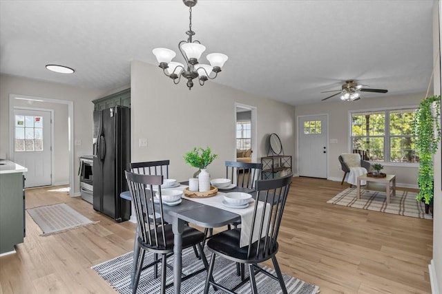 650 Wall Rd, Cunningham, TN 37052 - dining area featuring baseboards, light wood-style flooring, and ceiling fan with notable chandelier