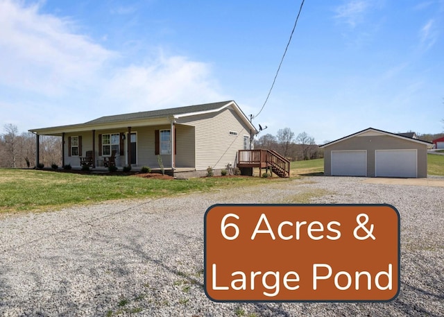 650 Wall Rd, Cunningham, TN 37052 - view of front of house featuring a front yard, an outdoor structure, a porch, and a garage