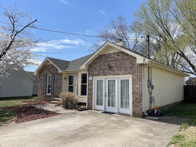 1222 Marla Dr, Clarksville, TN 37042 - view of front of property with a chimney, brick siding, a shingled roof, and a patio