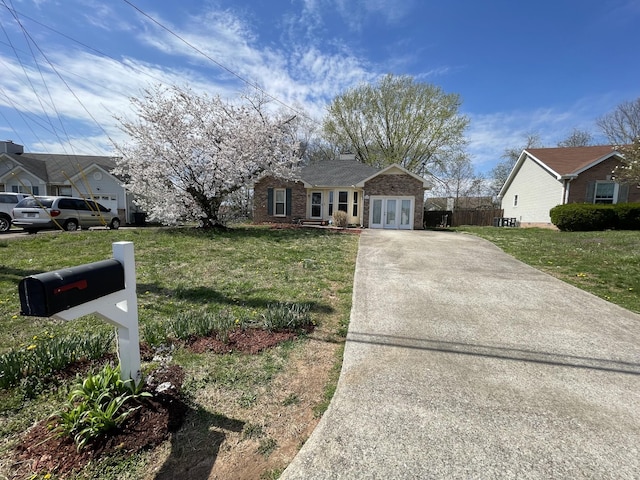 1222 Marla Dr, Clarksville, TN 37042 - single story home featuring french doors, driveway, a front yard, and brick siding