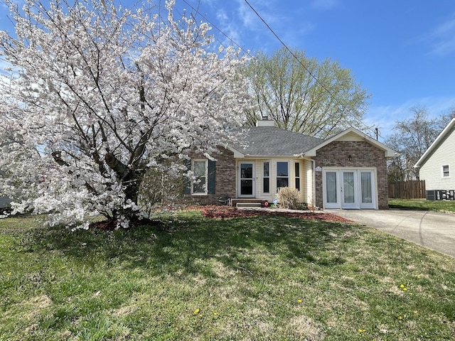 1222 Marla Dr, Clarksville, TN 37042 - ranch-style house featuring brick siding, french doors, and a chimney