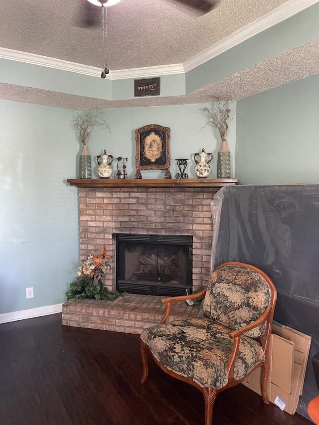 1222 Marla Dr, Clarksville, TN 37042 - living area featuring ornamental molding, wood finished floors, a brick fireplace, a textured ceiling, and baseboards