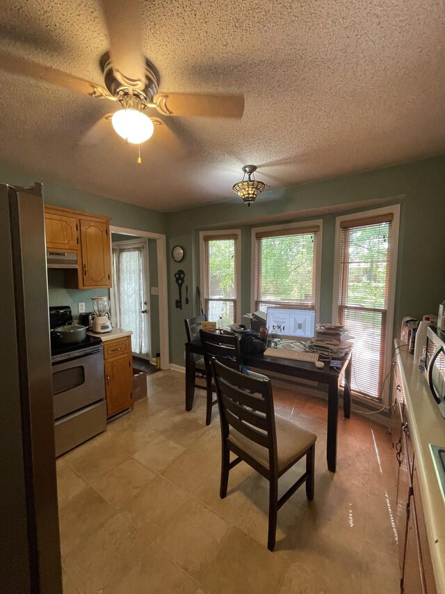 1222 Marla Dr, Clarksville, TN 37042 - kitchen featuring stainless steel appliances, under cabinet range hood, a textured ceiling, light countertops, and light tile patterned floors