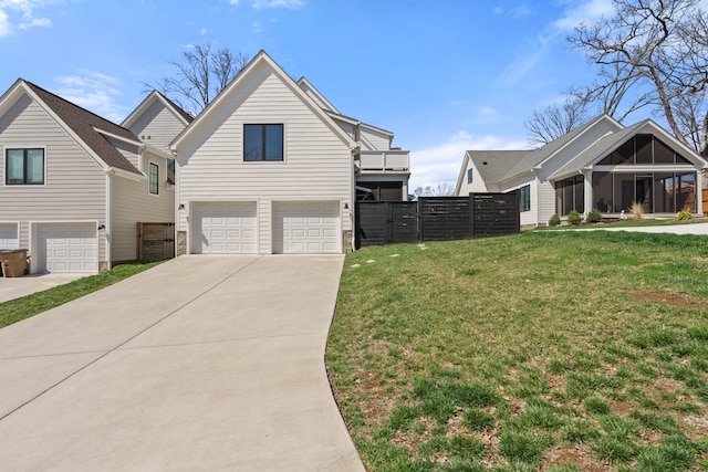 128 37th Ave N, Nashville, TN 37209 - view of front facade with an attached garage, fence, driveway, and a front yard