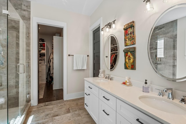 128 37th Ave N, Nashville, TN 37209 - full bath featuring a sink, a stall shower, double vanity, and a spacious closet