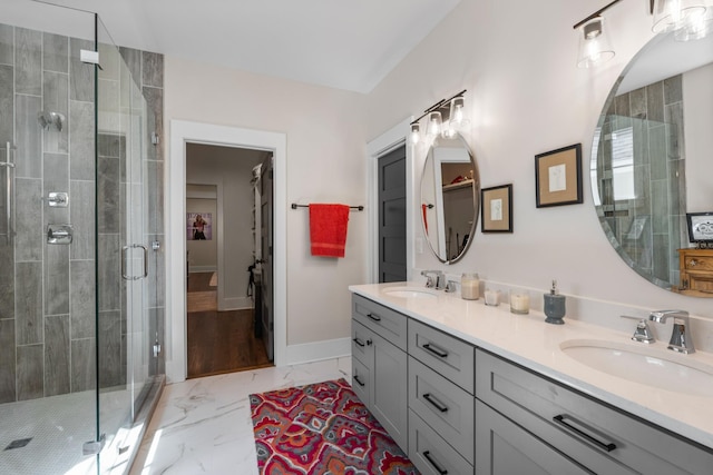 128 37th Ave N, Nashville, TN 37209 - full bathroom with a spacious closet, a shower stall, a sink, and marble finish floor
