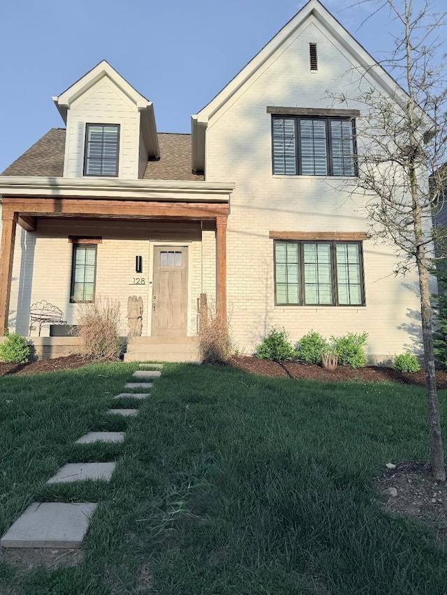 128 37th Ave N, Nashville, TN 37209 - traditional-style home with a shingled roof, a front yard, and brick siding