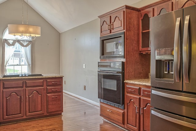 kitchen featuring stainless steel fridge, lofted ceiling, oven, built in microwave, and light wood finished floors