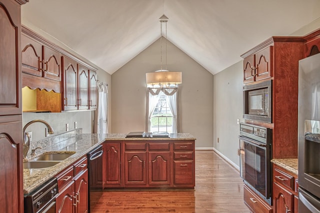 kitchen with a sink, a chandelier, appliances with stainless steel finishes, a peninsula, and dark wood finished floors