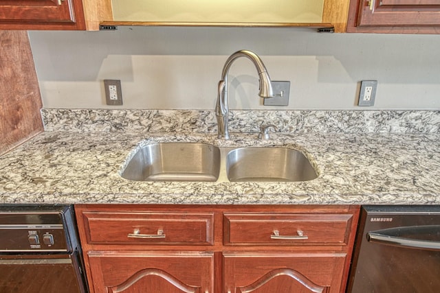 details featuring dishwashing machine, a sink, and light stone counters