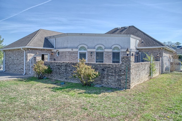 view of property exterior featuring a lawn, a garage, and fence