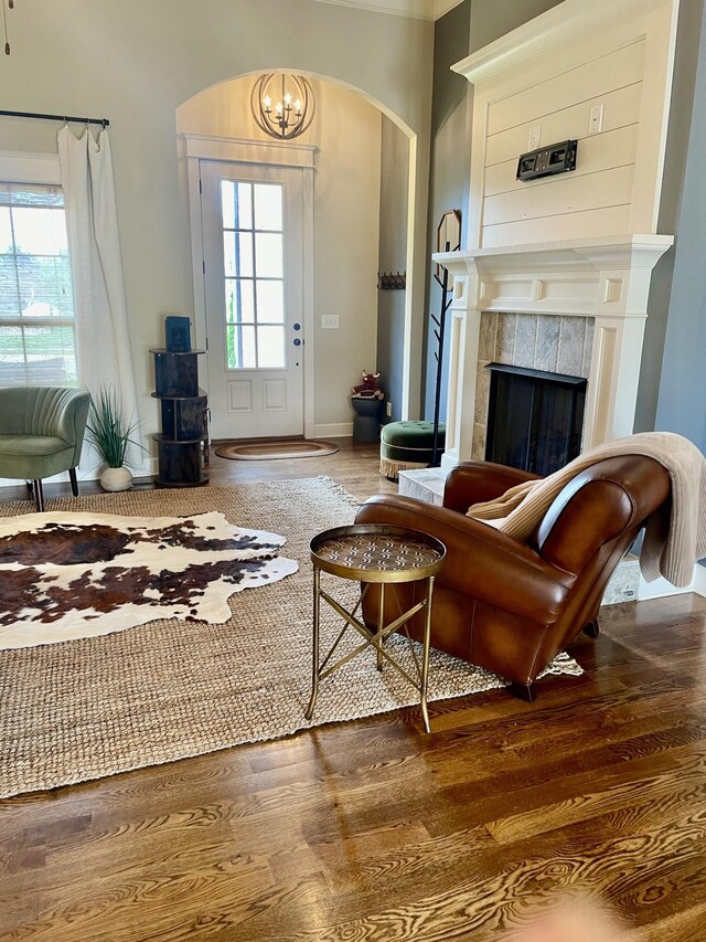 832 Brook Trl, Lebanon, TN 37087 - living room with arched walkways, healthy amount of natural light, a tiled fireplace, and a chandelier