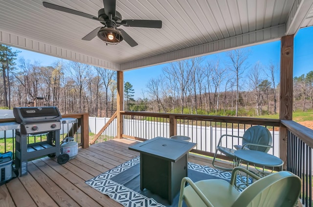 wooden terrace with a grill and ceiling fan