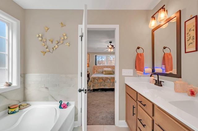 bathroom with double vanity, a sink, ensuite bathroom, and a garden tub
