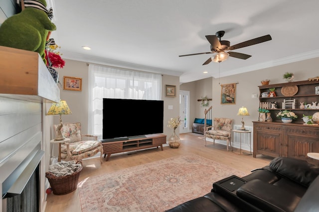 living room with wood finished floors, ceiling fan, and ornamental molding