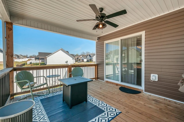 deck featuring a residential view and a ceiling fan