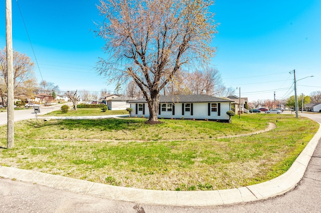 ranch-style home with a front lawn