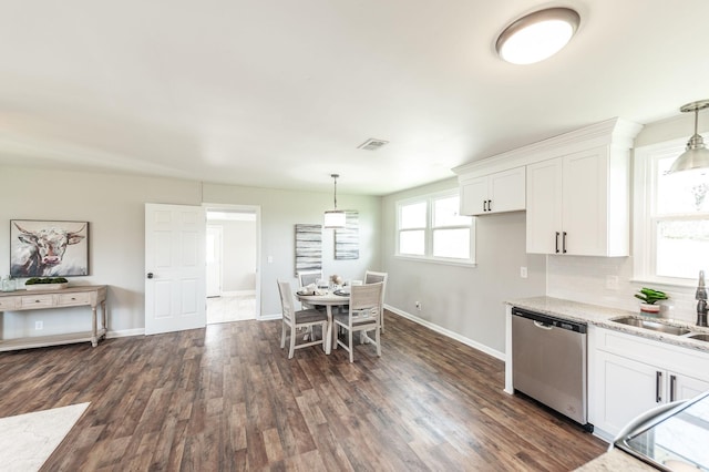 kitchen with white cabinetry, backsplash, a sink, light stone counters, and dishwasher