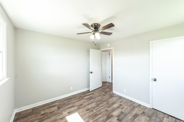 unfurnished bedroom with baseboards, wood finished floors, and a ceiling fan