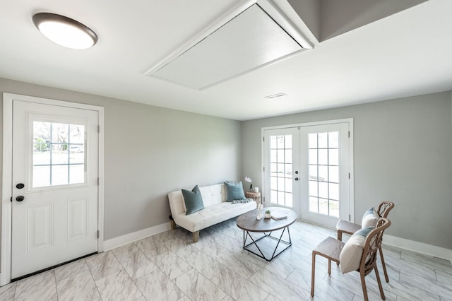 living room featuring french doors, baseboards, attic access, and visible vents