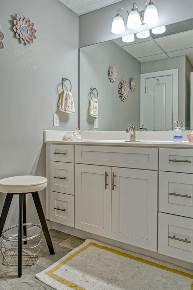 bathroom featuring a drop ceiling and vanity