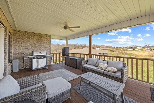 deck with an outdoor living space, a grill, and ceiling fan