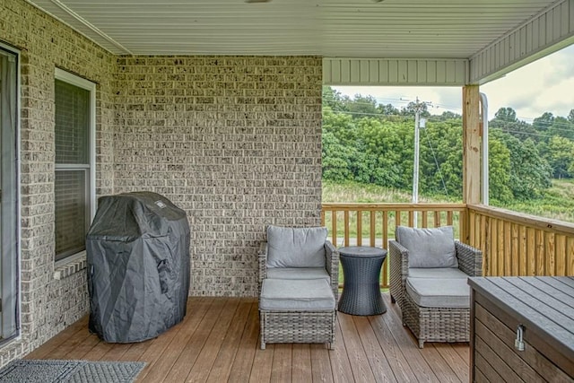 wooden deck featuring an outdoor hangout area and area for grilling