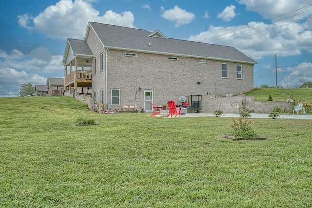 back of property featuring a lawn and a patio area