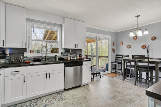 kitchen with dishwasher, a sink, dark countertops, and decorative backsplash