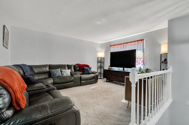 living area featuring light colored carpet and a textured ceiling