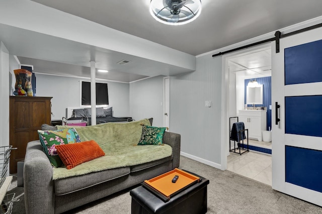 carpeted living area with baseboards, visible vents, a barn door, and tile patterned flooring