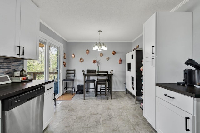 kitchen with crown molding, dishwasher, dark countertops, white cabinets, and an inviting chandelier