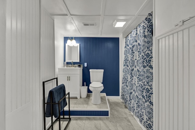 full bathroom with toilet, vanity, and visible vents