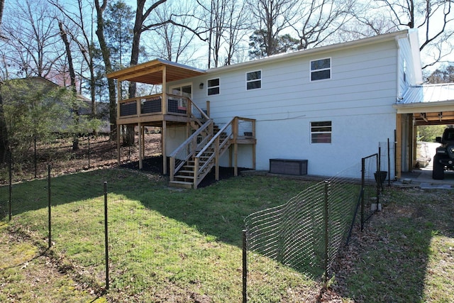 back of property featuring a lawn, metal roof, stairway, and a deck