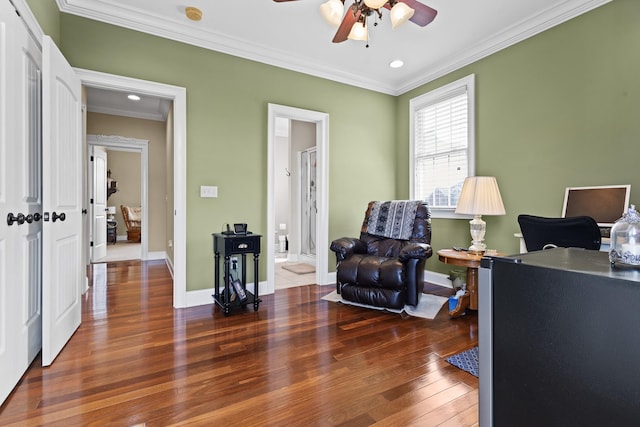 office space featuring baseboards, hardwood / wood-style flooring, ornamental molding, and a ceiling fan