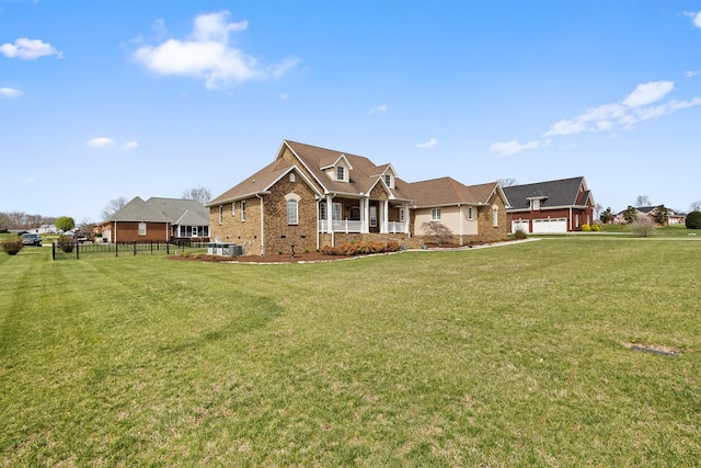 view of front of house featuring brick siding, fence, a porch, and a front yard