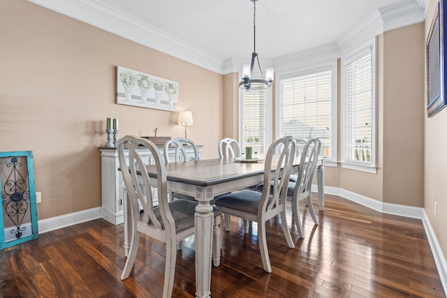 dining space featuring an inviting chandelier, dark wood-style flooring, ornamental molding, and baseboards