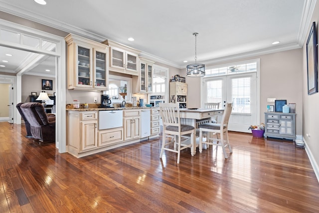 kitchen with french doors, cream cabinets, crown molding, and dark wood-type flooring