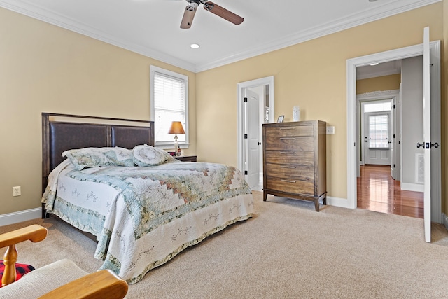 carpeted bedroom featuring baseboards, ornamental molding, visible vents, and multiple windows
