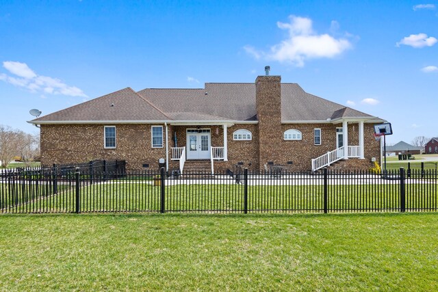 view of front of home featuring a front lawn, french doors, and brick siding