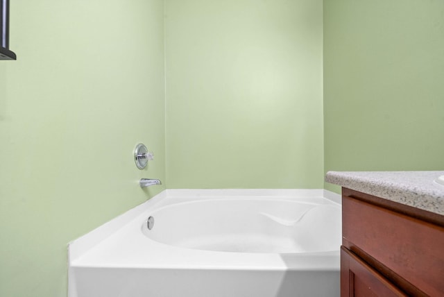 bathroom with vanity and a garden tub