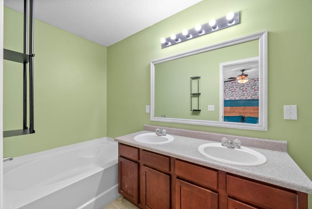 bathroom with double vanity, a bath, a sink, and tile patterned floors