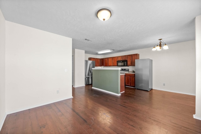 kitchen featuring freestanding refrigerator, a notable chandelier, black microwave, and dark wood finished floors