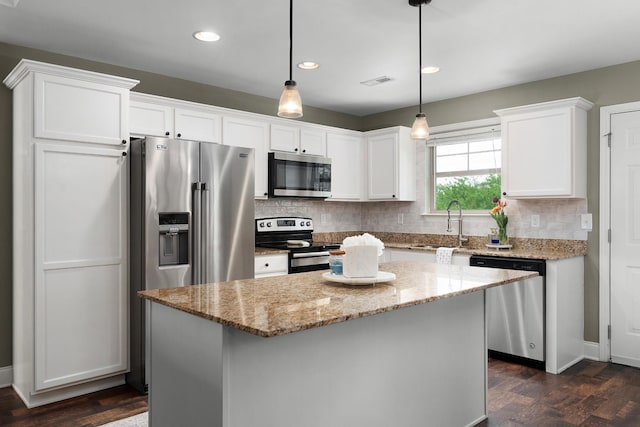 157 Battle Bluff Dr, Rossville, GA 30741 - kitchen with white cabinetry, tasteful backsplash, a center island, stainless steel appliances, and visible vents