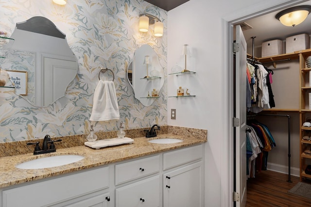 157 Battle Bluff Dr, Rossville, GA 30741 - full bath with wallpapered walls, a sink, a walk in closet, and double vanity