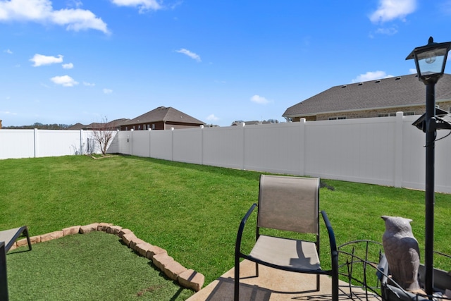 view of yard with a fenced backyard